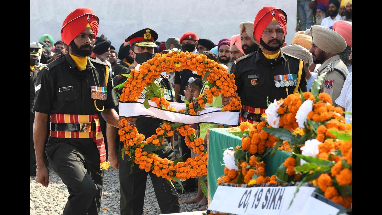 Indian army officers (C) lay a wreath over the coffin of slain soldier Mandeep Singh, who was killed in an encounter. Government forces killed five suspected rebels in India-administered Kashmir, police, a day after militants shot dead five soldiers. Pic/AFP